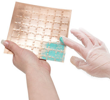 Gilders paste being applied to the metal sheet